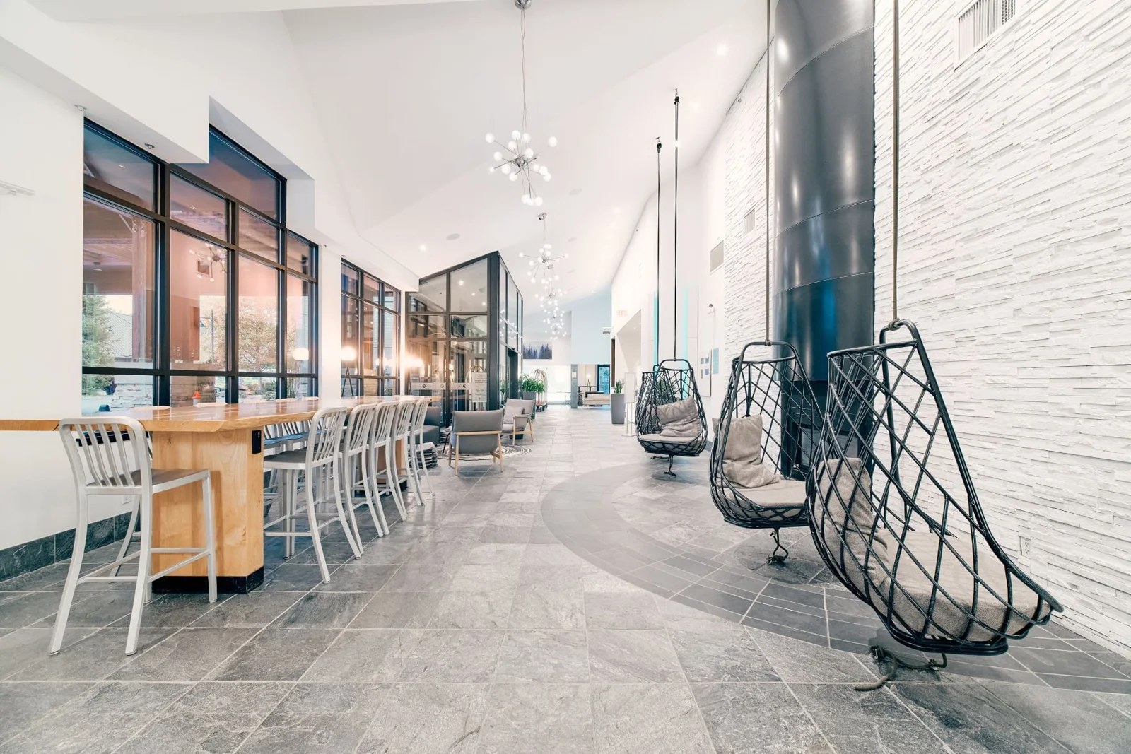 Lobby seating and hanging chairs at Aava Whistler Hotel