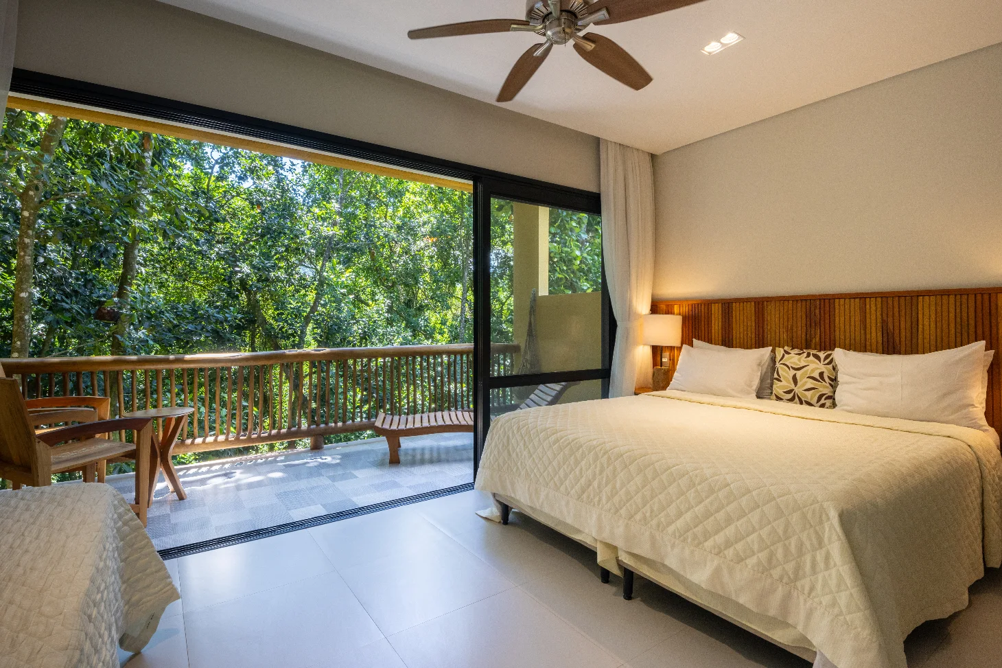 Forest-facing guest room and balcony at Pousada Naturalia