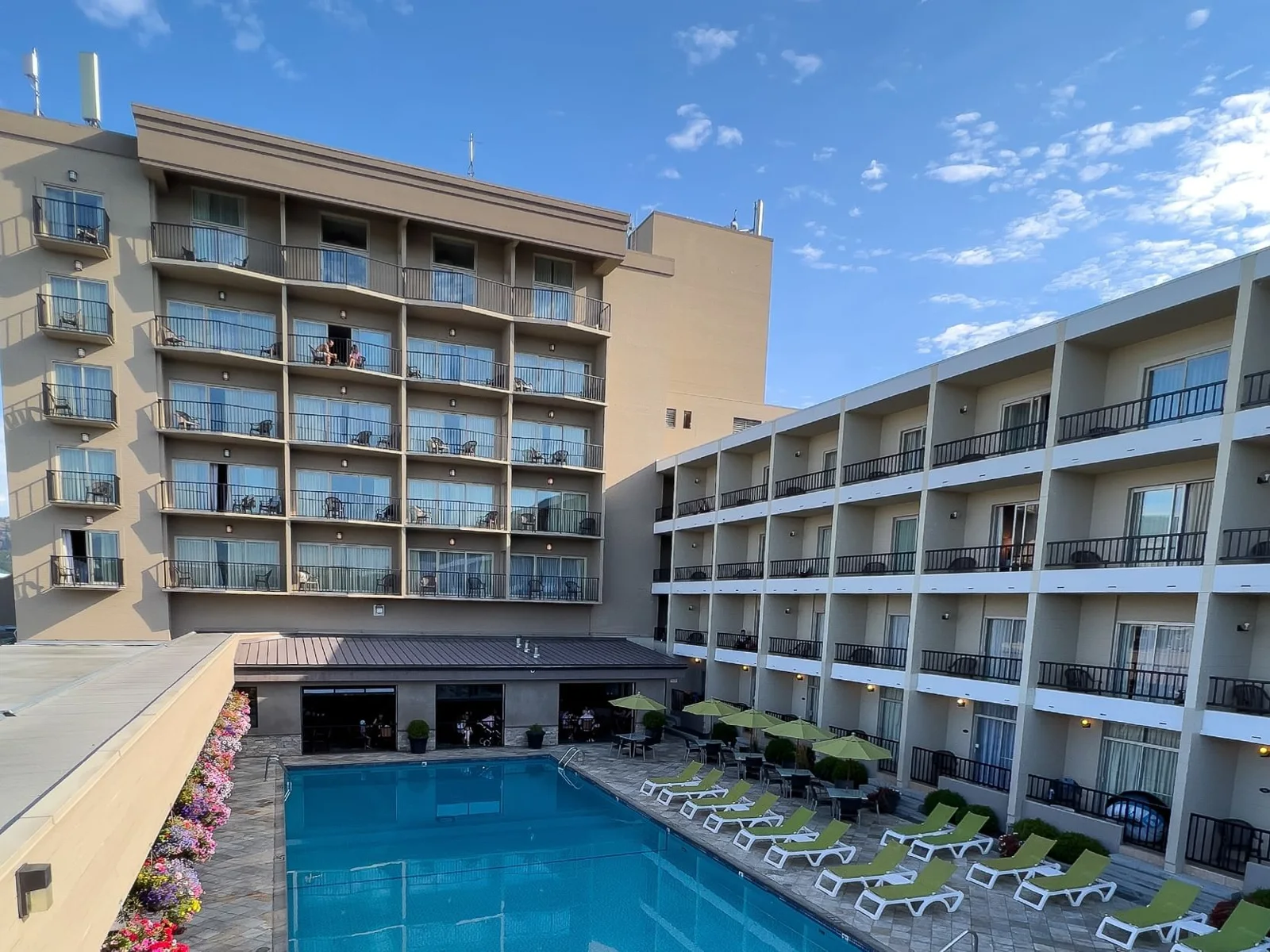Outdoor pool and buildings at Coast Capri Hotel