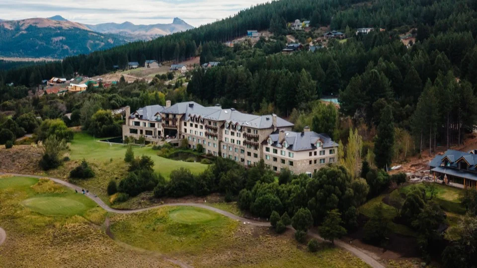 Loi Suites Chapelco surrounded by wooded grounds