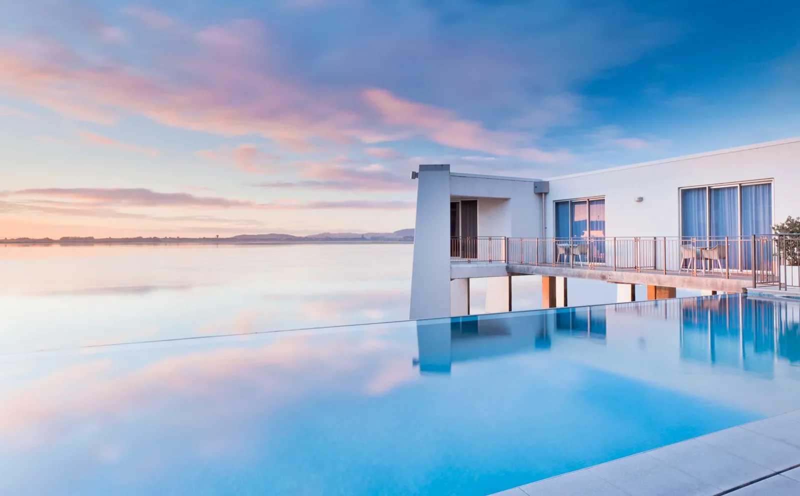 Infinity-edge pool and waterfront buildings at Trinity Wharf Tauranga