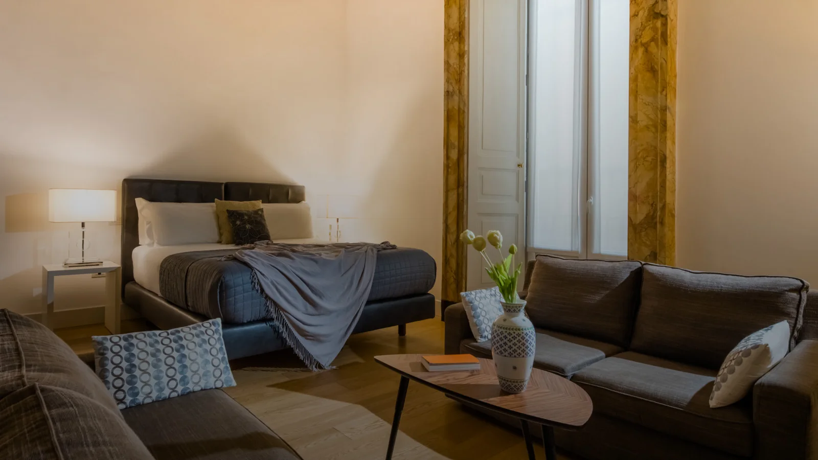Guest room and seating area at Santa Chiara Boutique Hotel in Naples