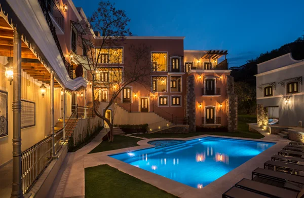 Pool and historic buildings at Villa María Cristina