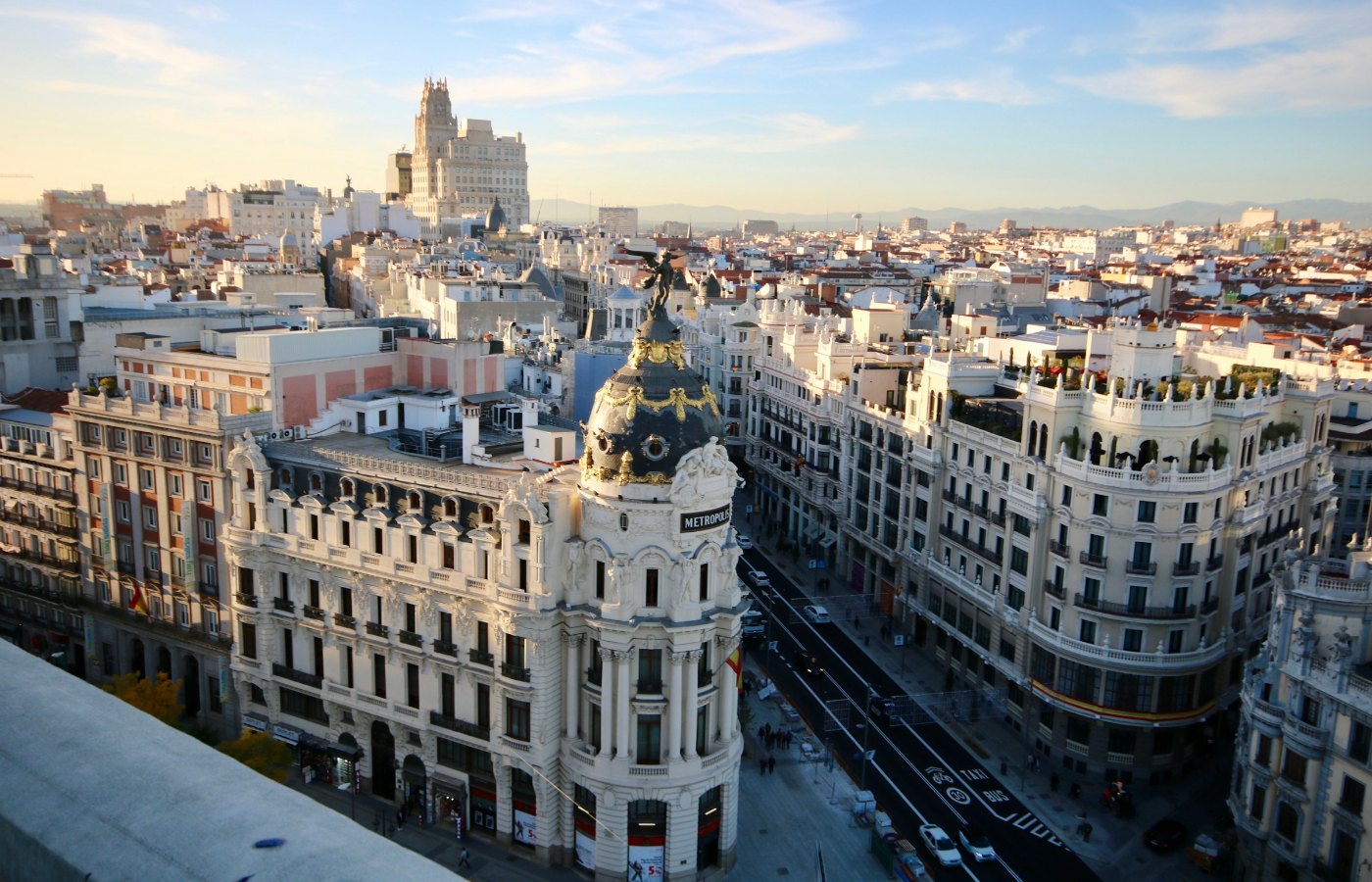 Gran Vía and the Metrópolis building in Madrid in warm evening light.