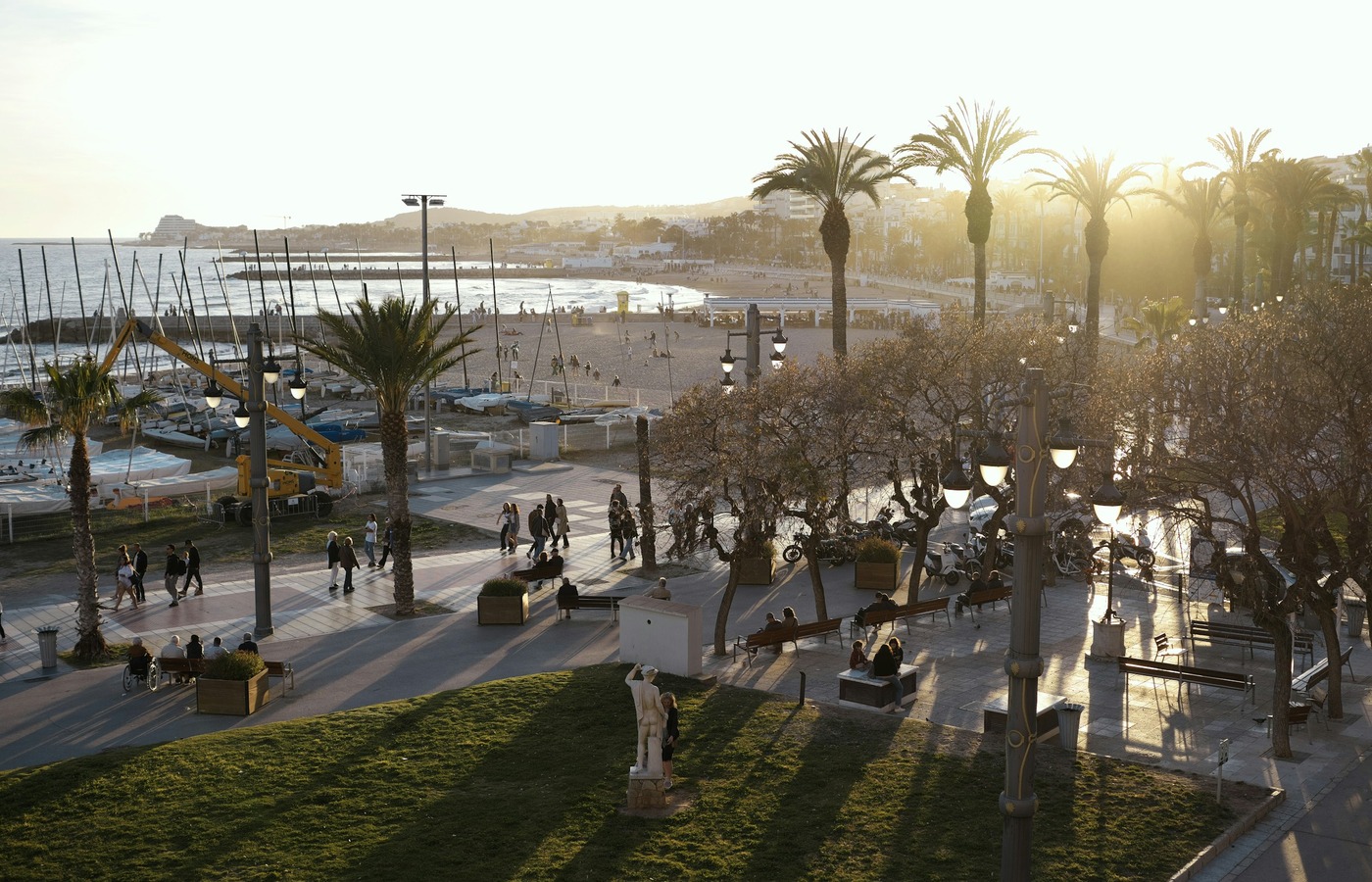 Palm trees beside the seafront promenade and beach in Sitges