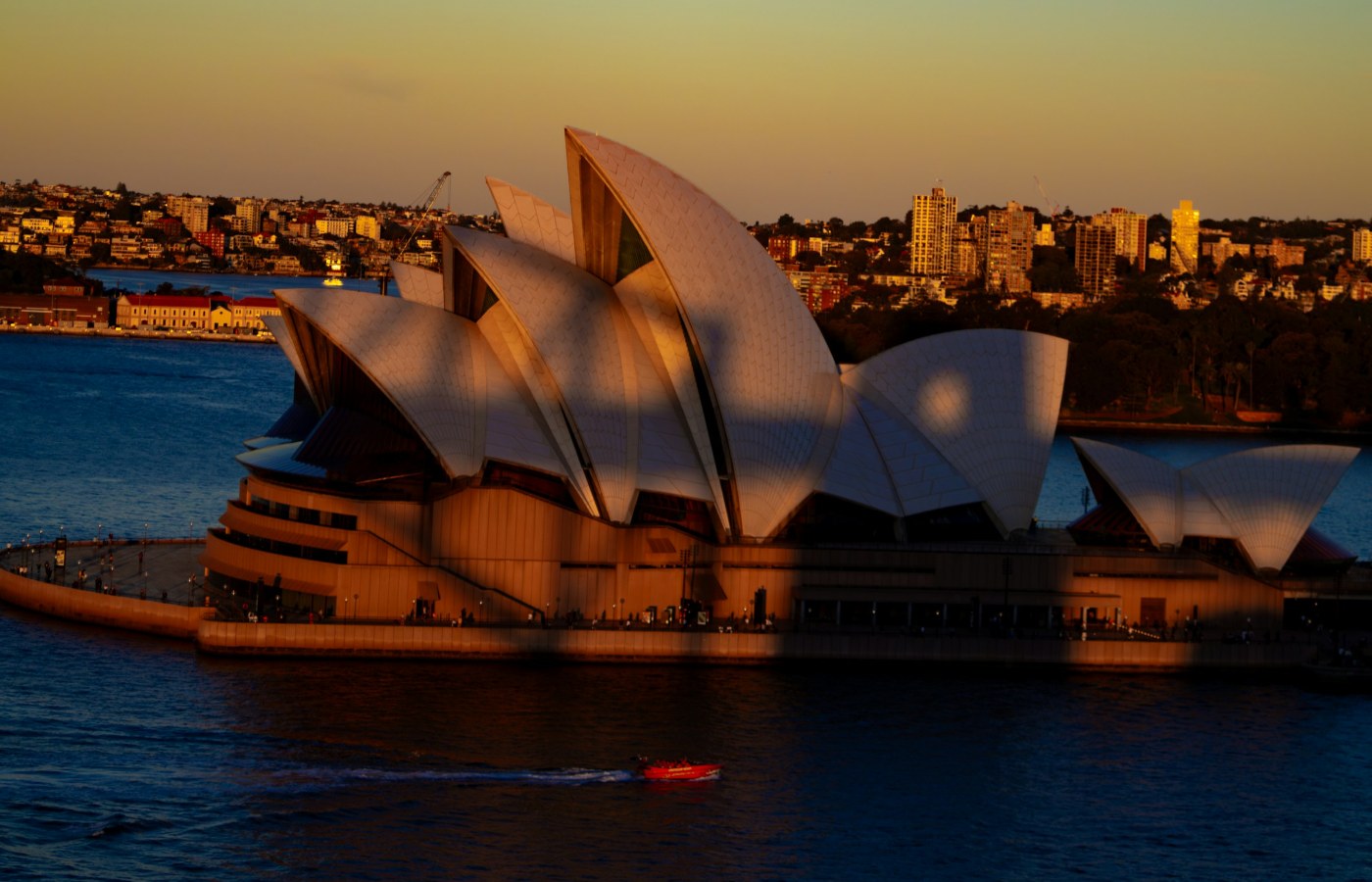 Sydney Opera House and harbour in warm sunset light