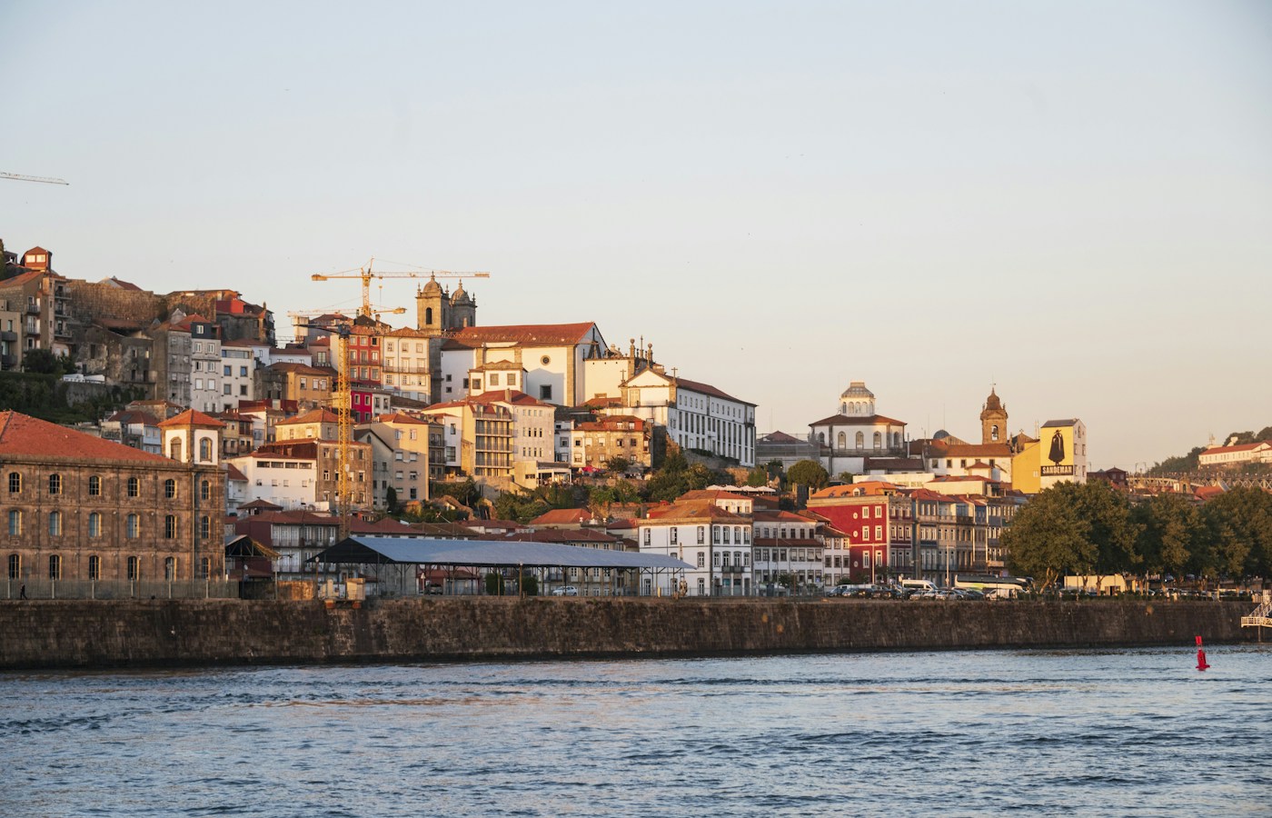 Vila Nova de Gaia waterfront buildings beside the Douro in warm evening light