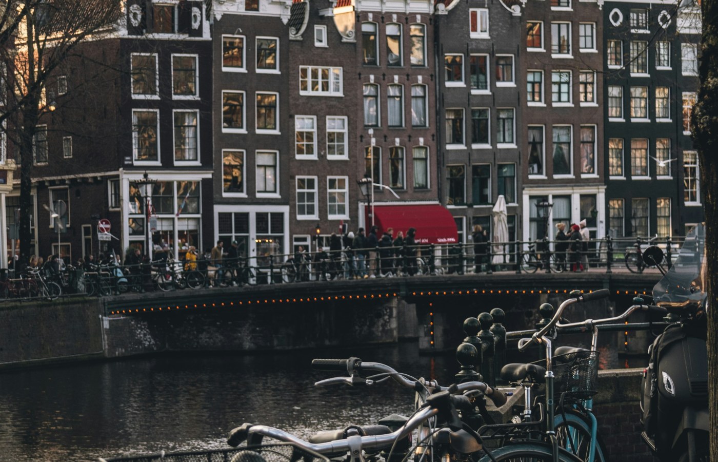 Historic canal houses and bicycles beside a canal in Amsterdam