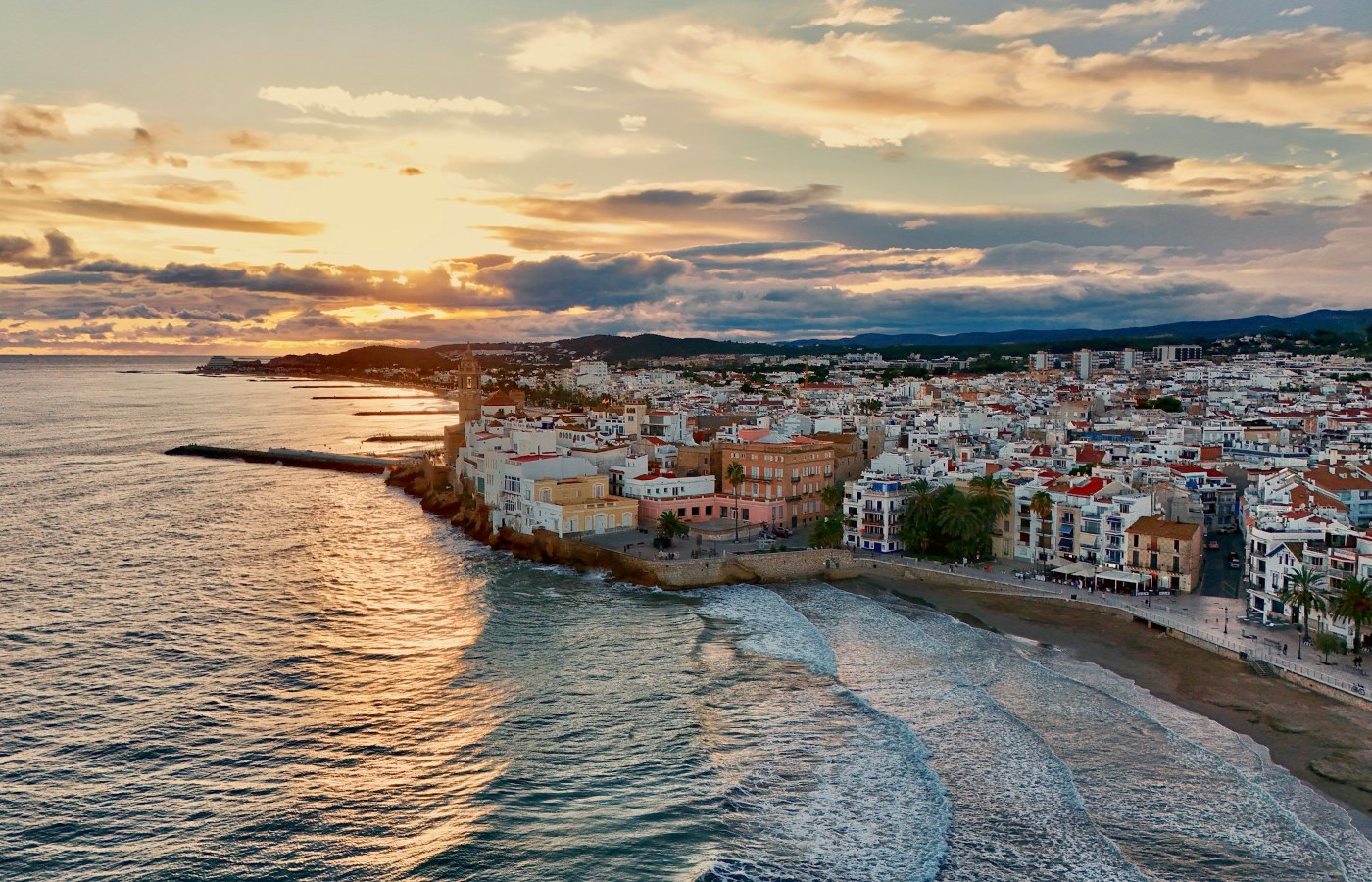 Sitges old town and Mediterranean coastline at sunset