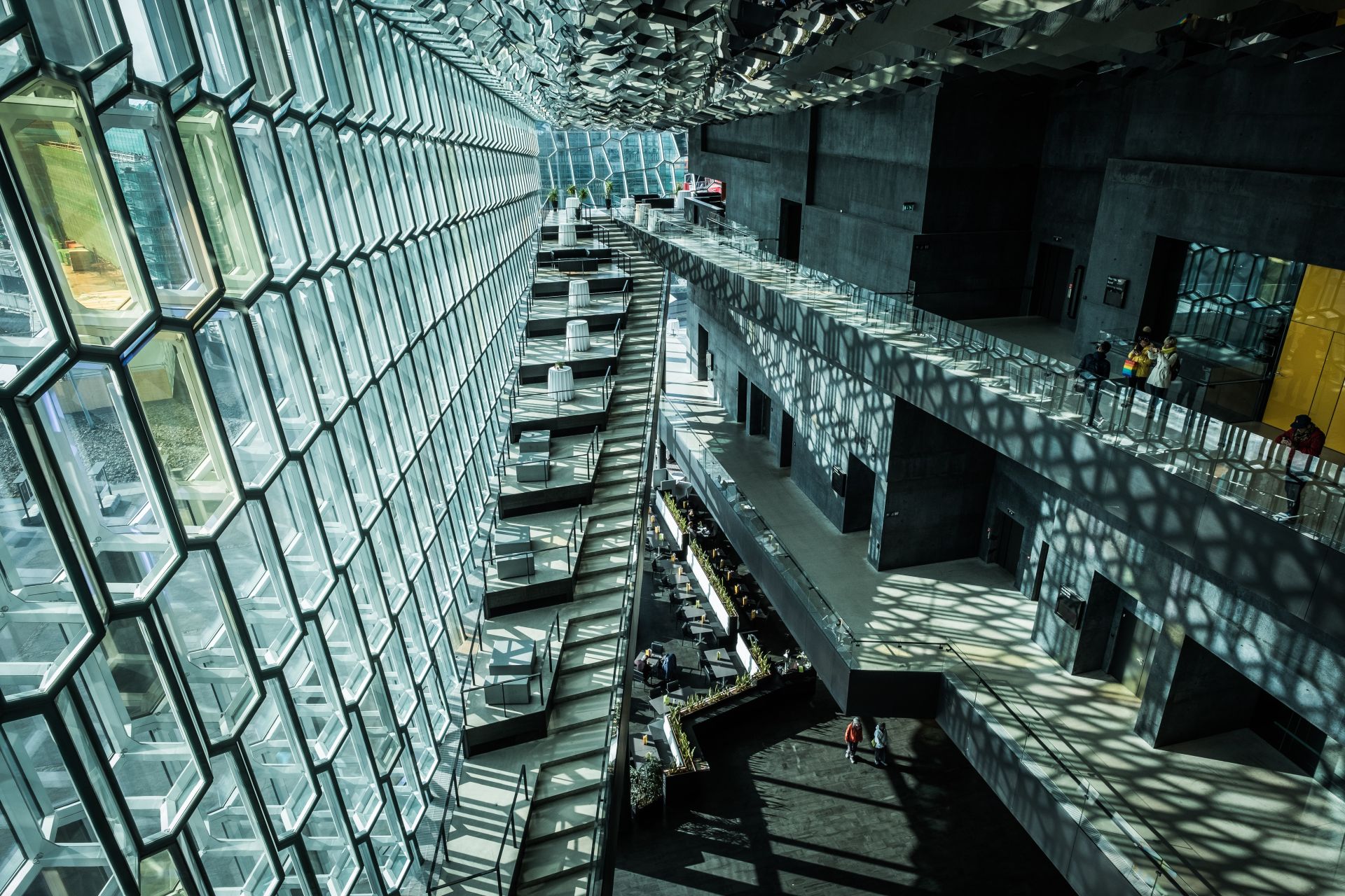Daylight and geometric shadows inside Harpa’s glass-fronted public spaces