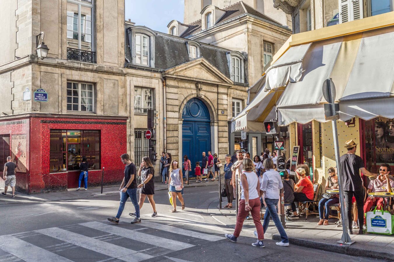 Rue Vieille-du-Temple in the Marais, with pedestrians, historic façades and café tables