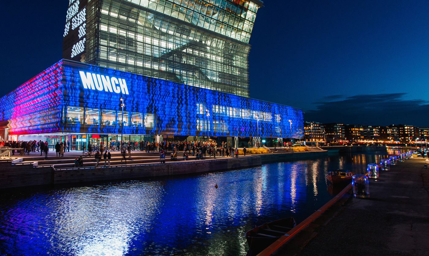 Archive photograph of MUNCH illuminated at night beside the water in Bjørvika