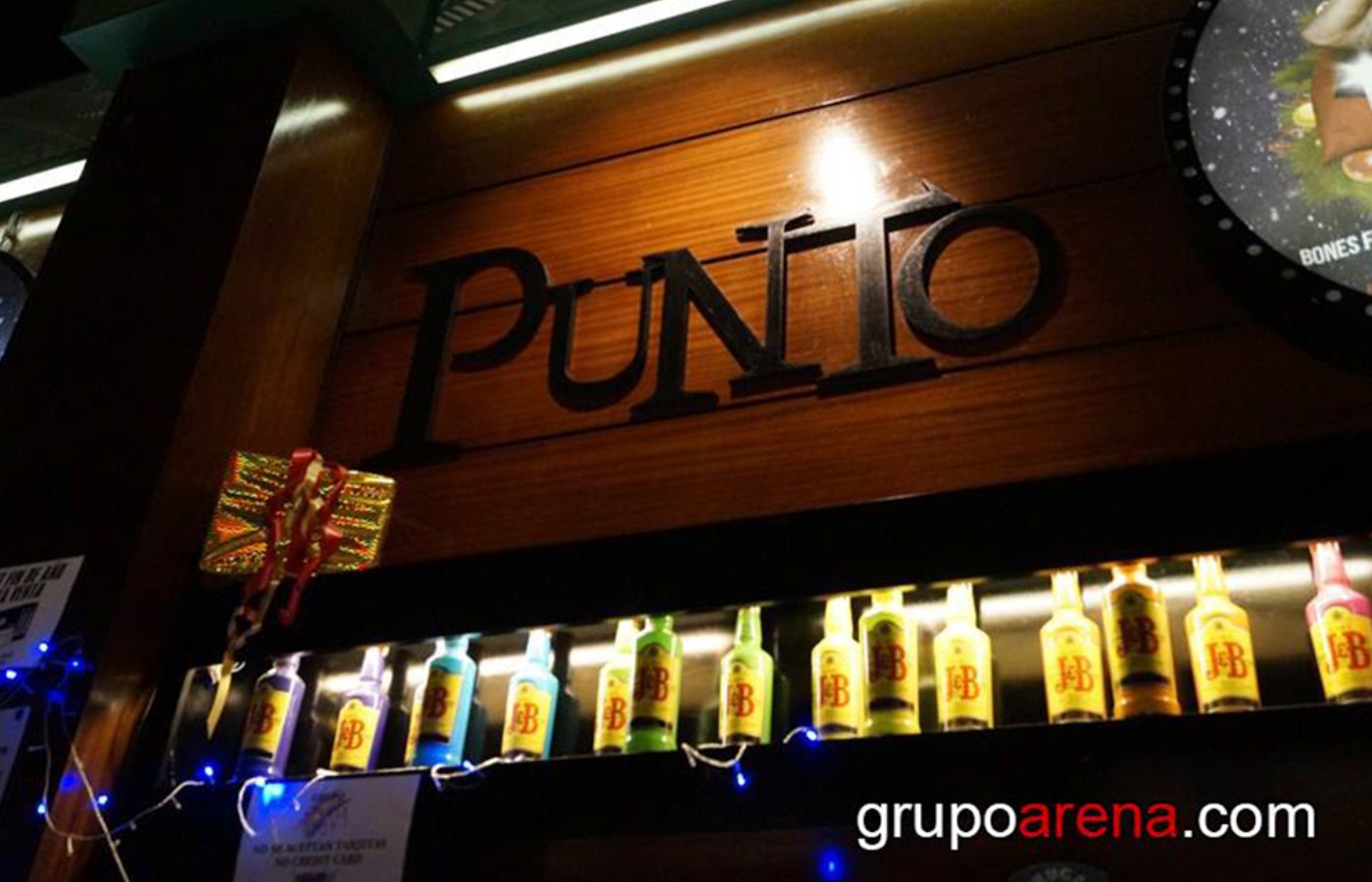 Punto BCN bar counter with its sign and illuminated bottles