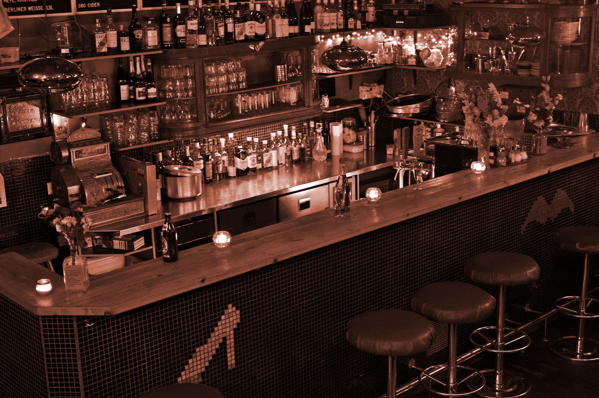 Silverfuture bar counter with bottles, candlelight and mirrored lamps